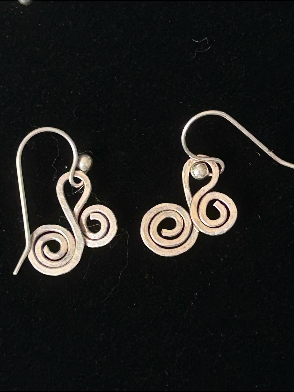 Handmade sterling silver earrings featuring a double spiral or curlicue design